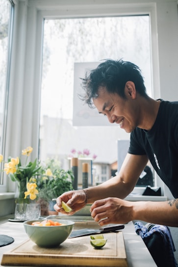 A happy person cooking a healthy meal in a cozy home kitchen.