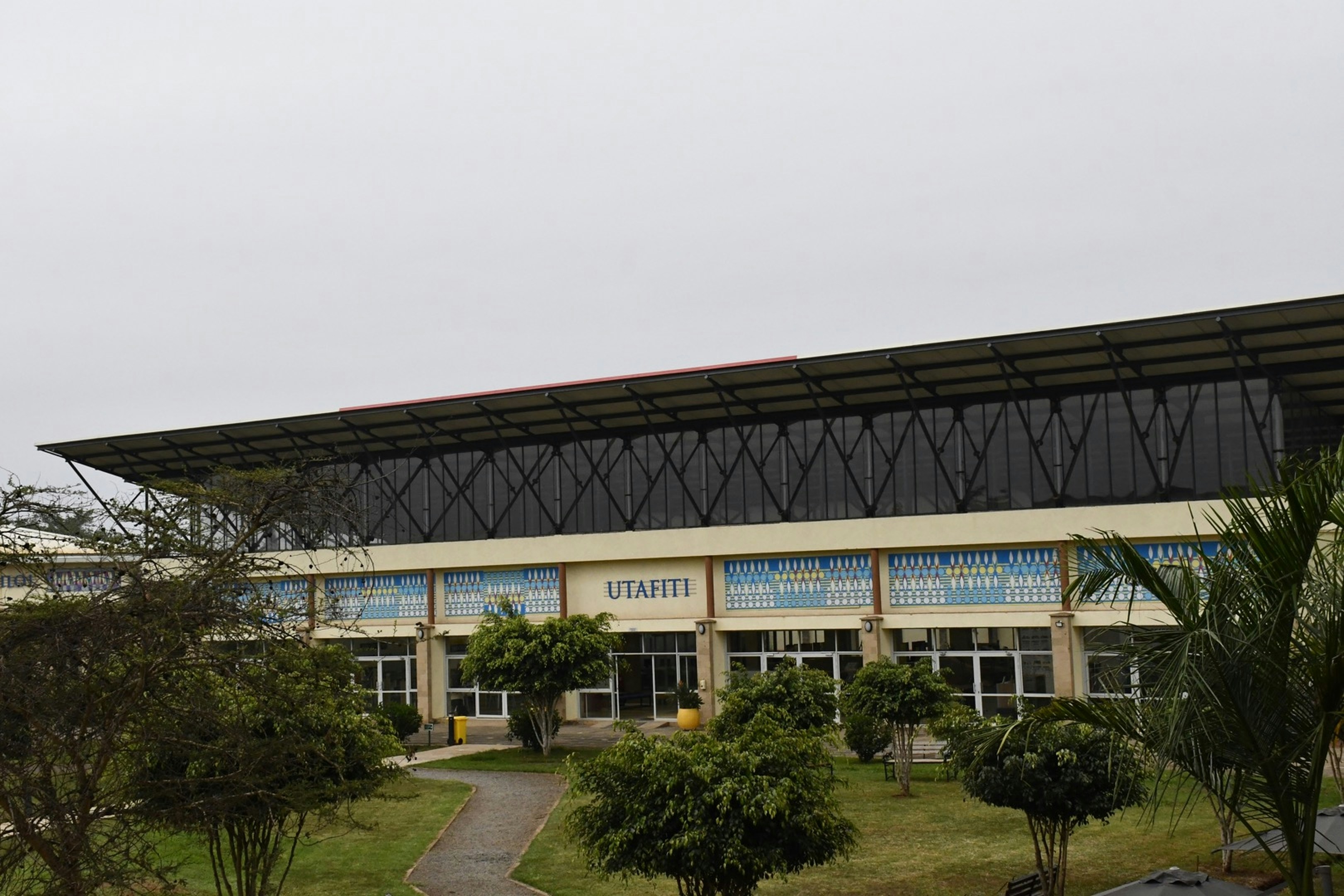 a large building with a walkway leading to it, 