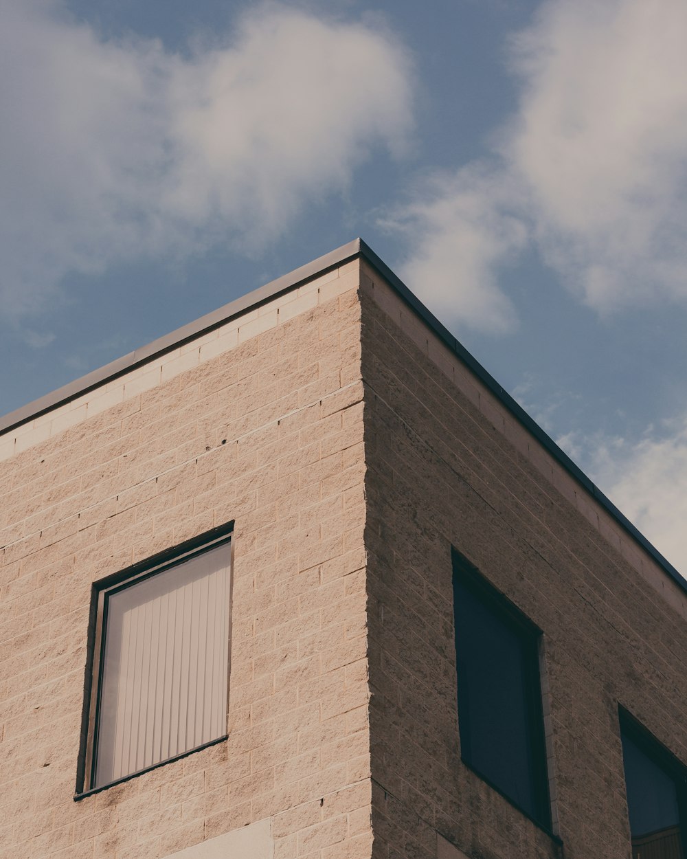 a tall brick building with a sky background