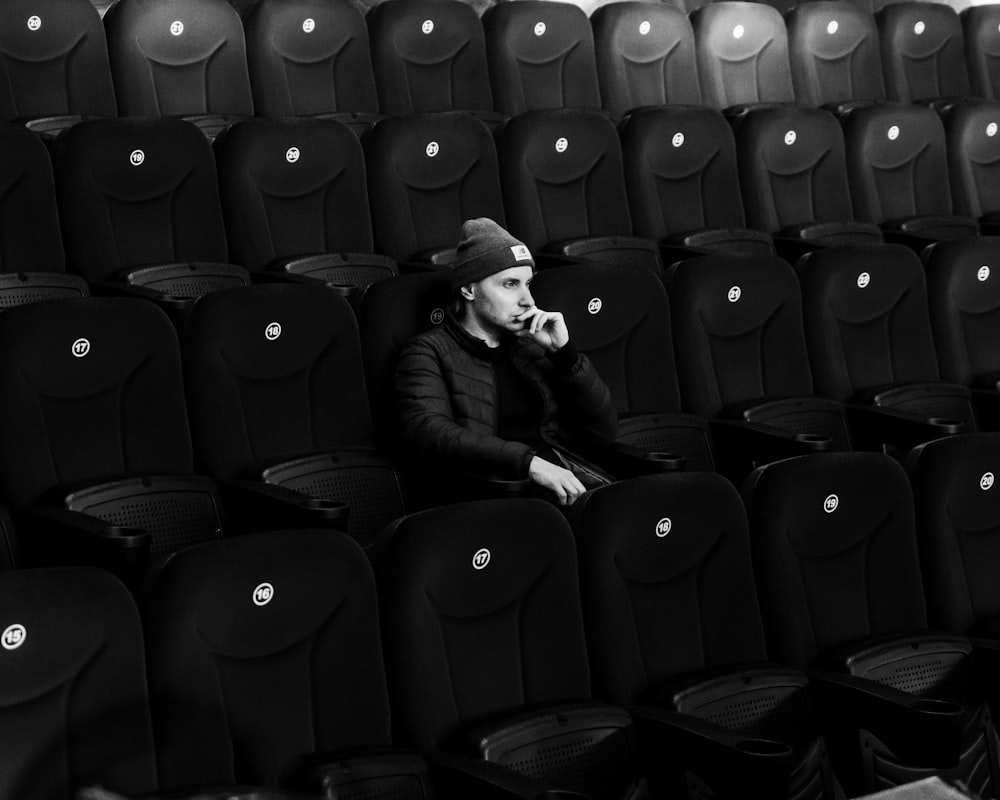 a man sitting in a row of empty seats