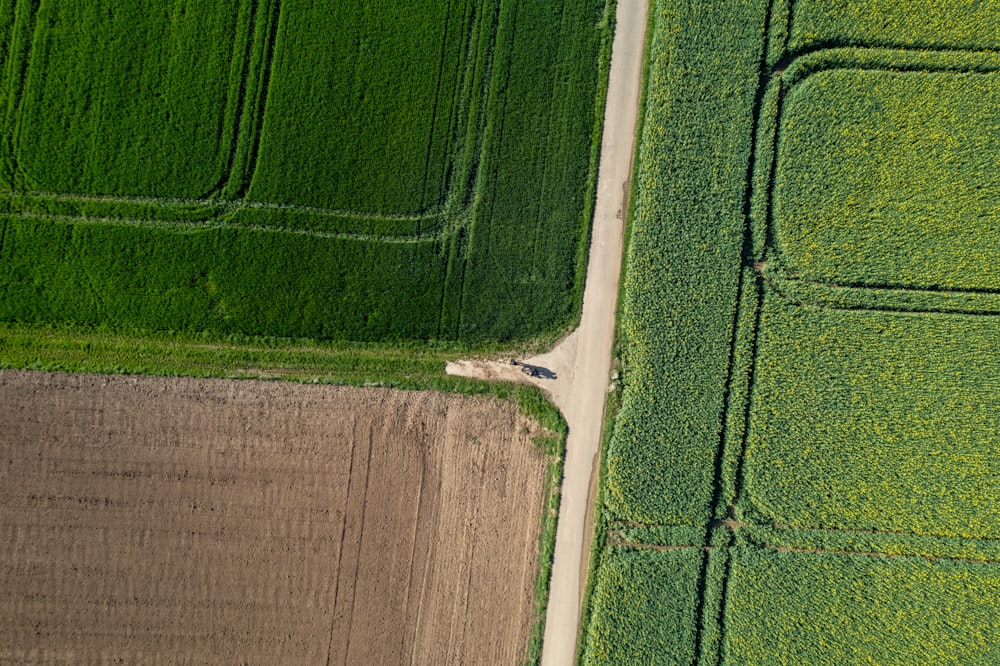 an aerial view of a road running through a field