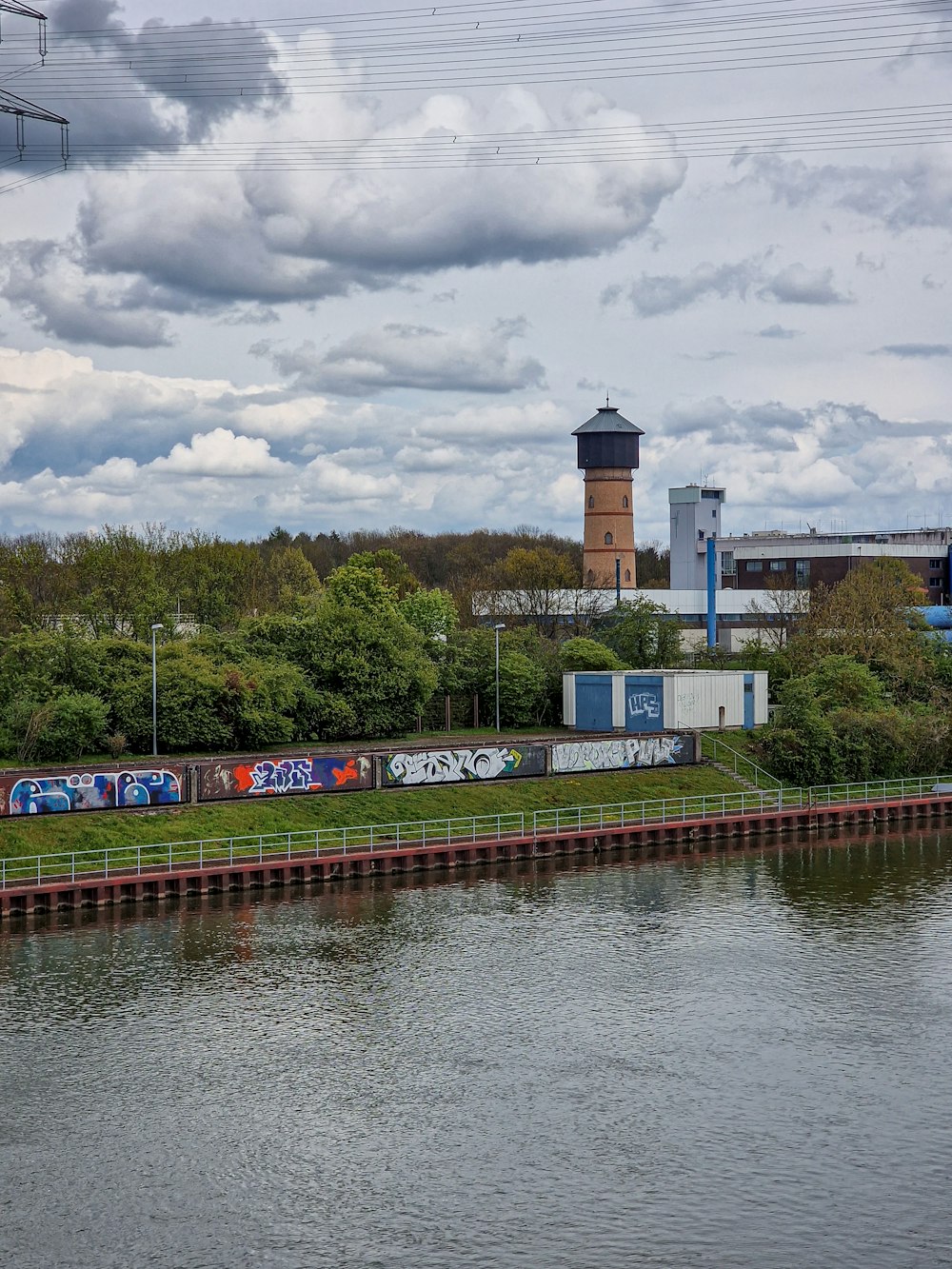 a train traveling down tracks next to a body of water