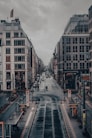 a city street with a train track going through it