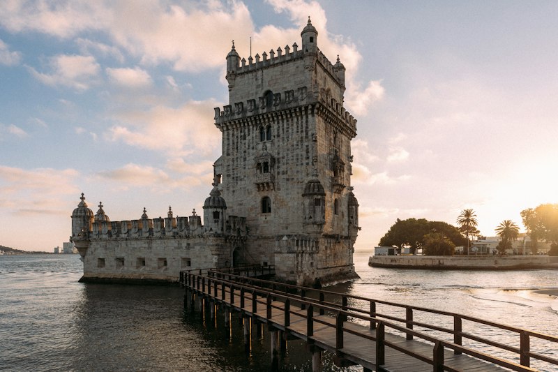 Belém Tower standing at the edge of the Tagus River in Lisbon