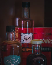 Elegant glass bottles filled with herbal extracts on a deep green background.