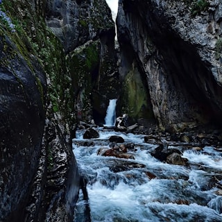 a small waterfall in the middle of a canyon