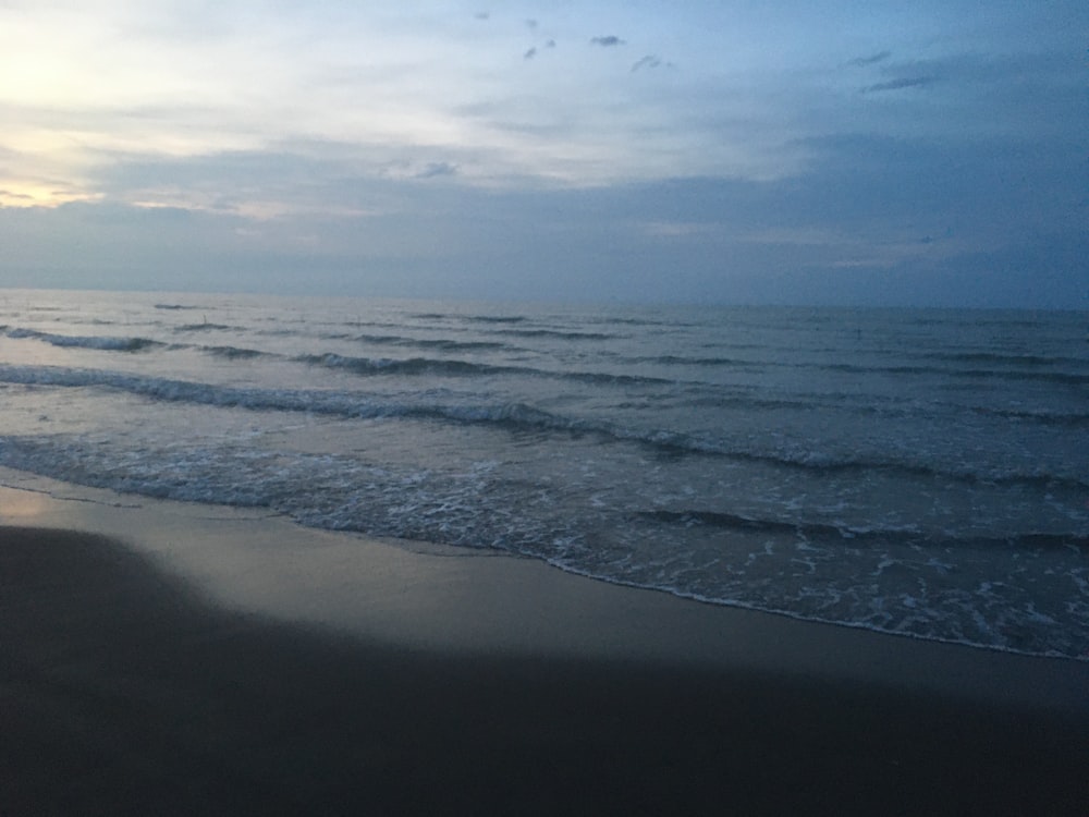 a beach with waves coming in to shore