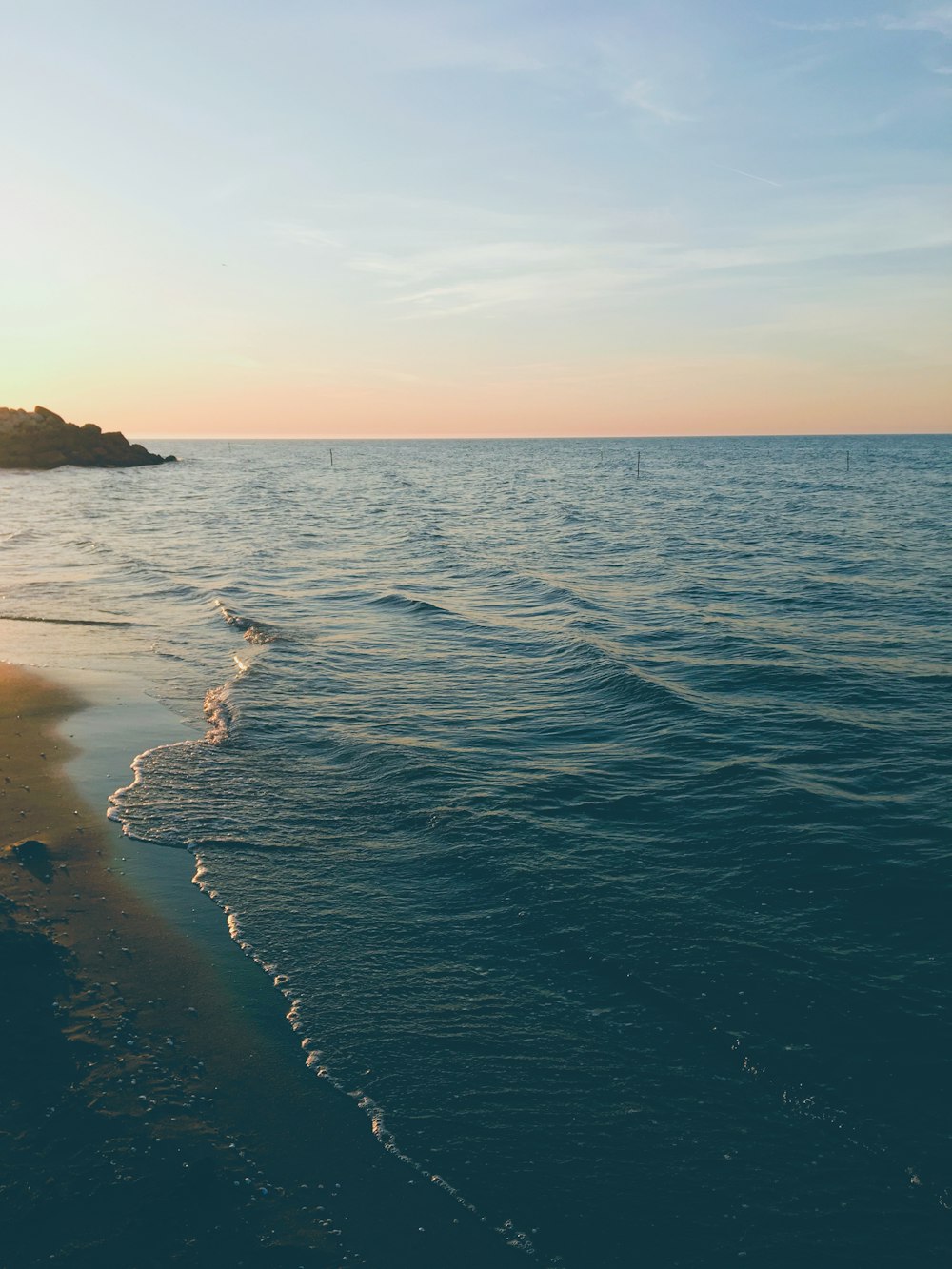 a body of water with a small island in the distance