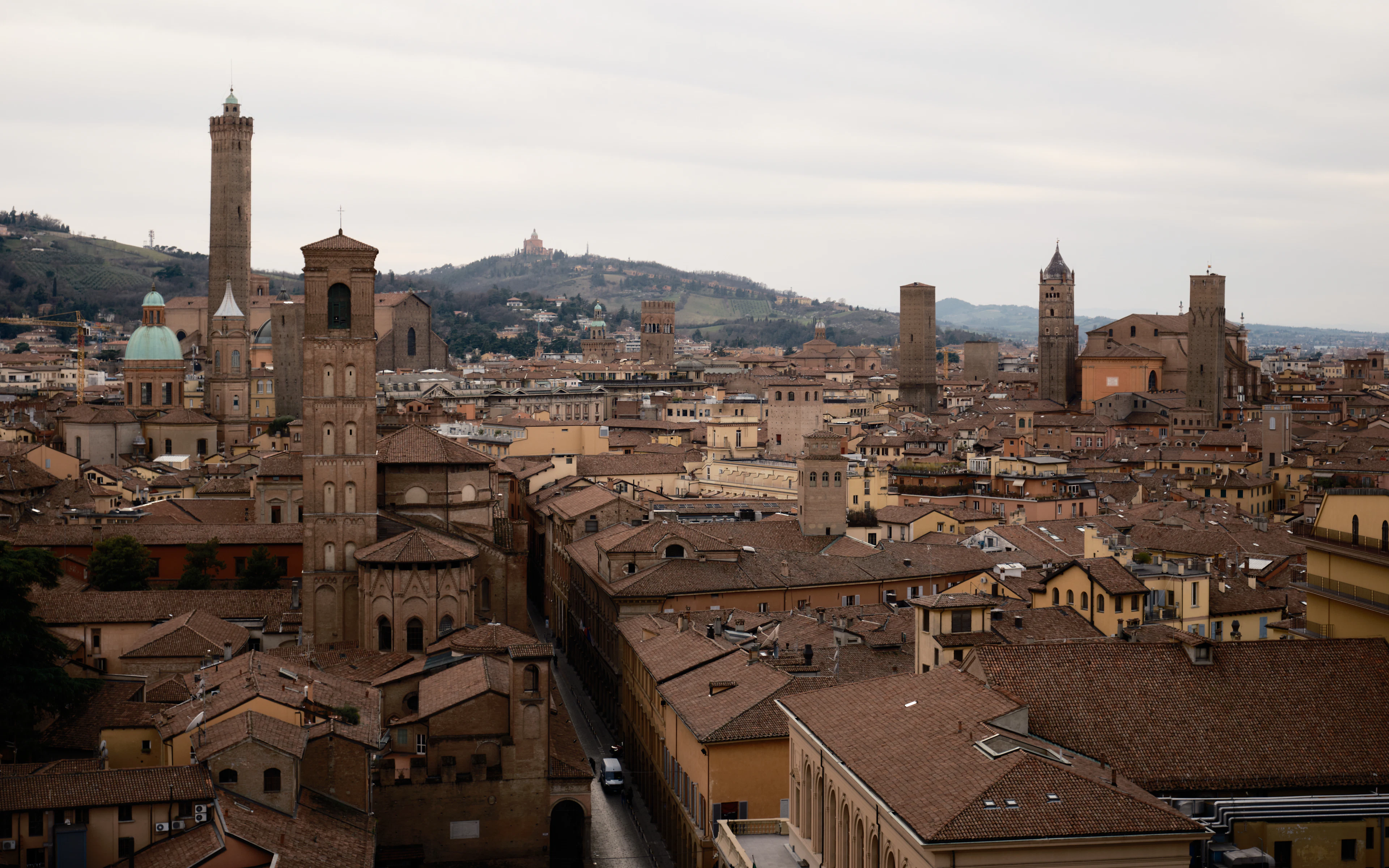 Bologna’s towers and red rooftops, with the San Luca sanctuary on the hill beyond