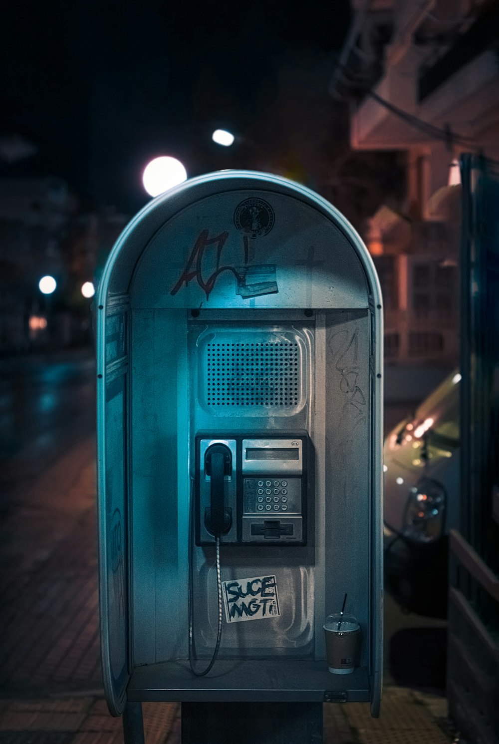 a phone booth on a city street at night