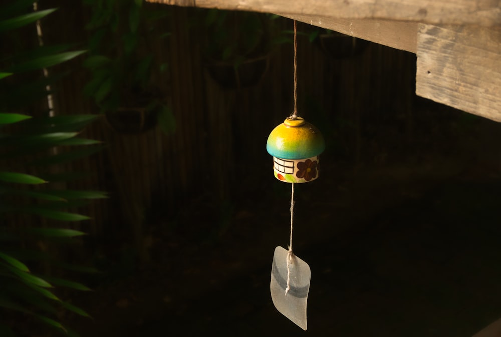 a bird feeder hanging from a wooden fence