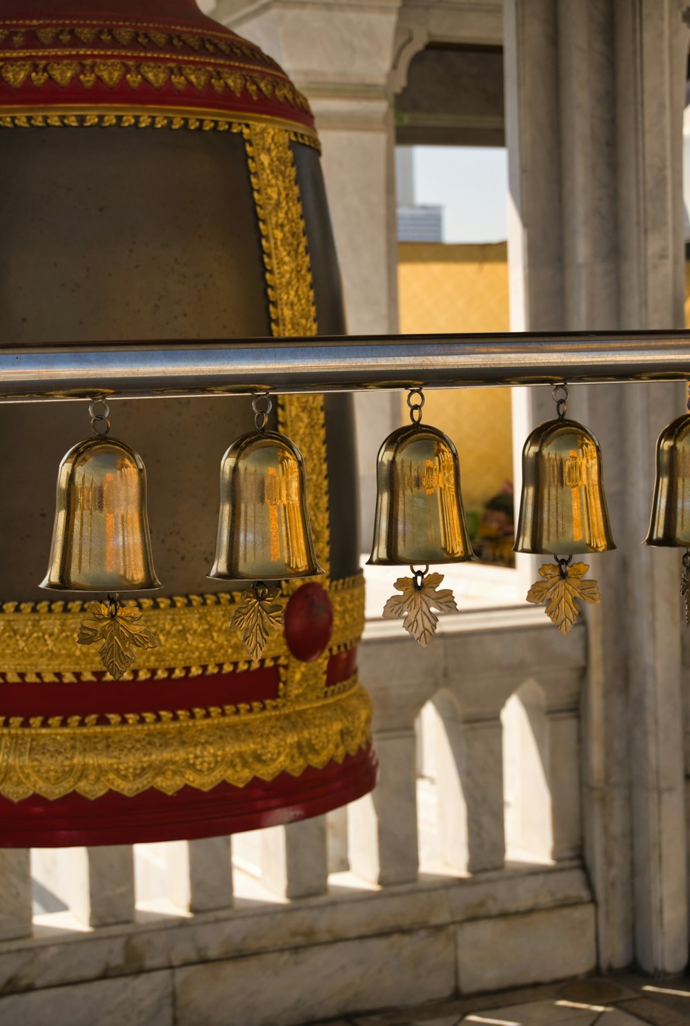 a group of bells hanging from a metal pole