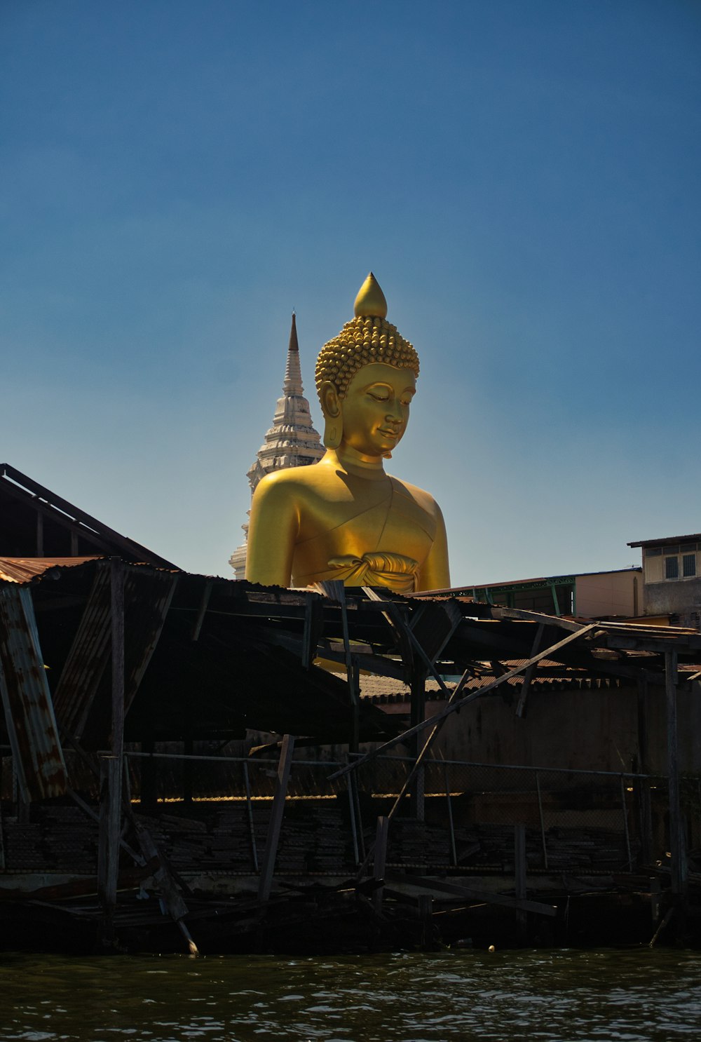 a large golden buddha statue sitting on top of a boat