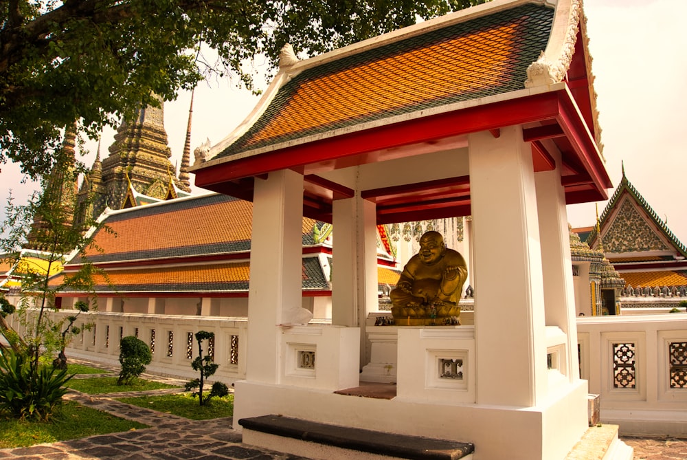 a statue of a person sitting in a pavilion