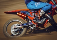 A dynamic shot of a powerful motorcycle kicking up dirt on a rugged off-road path.