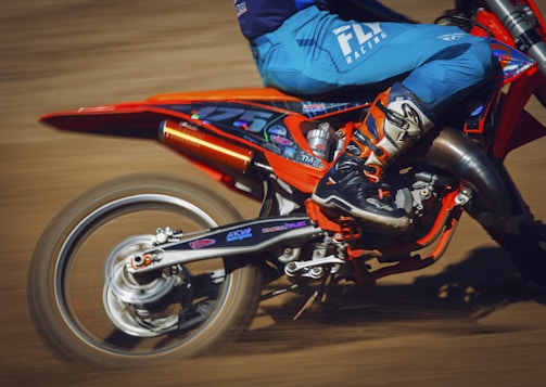Close-up of a Moto Grand Prix bike speeding on a racetrack.