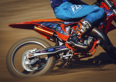 A close-up of a motorcycle's wheel kicking up dirt on a rugged trail, symbolizing excitement and freedom.