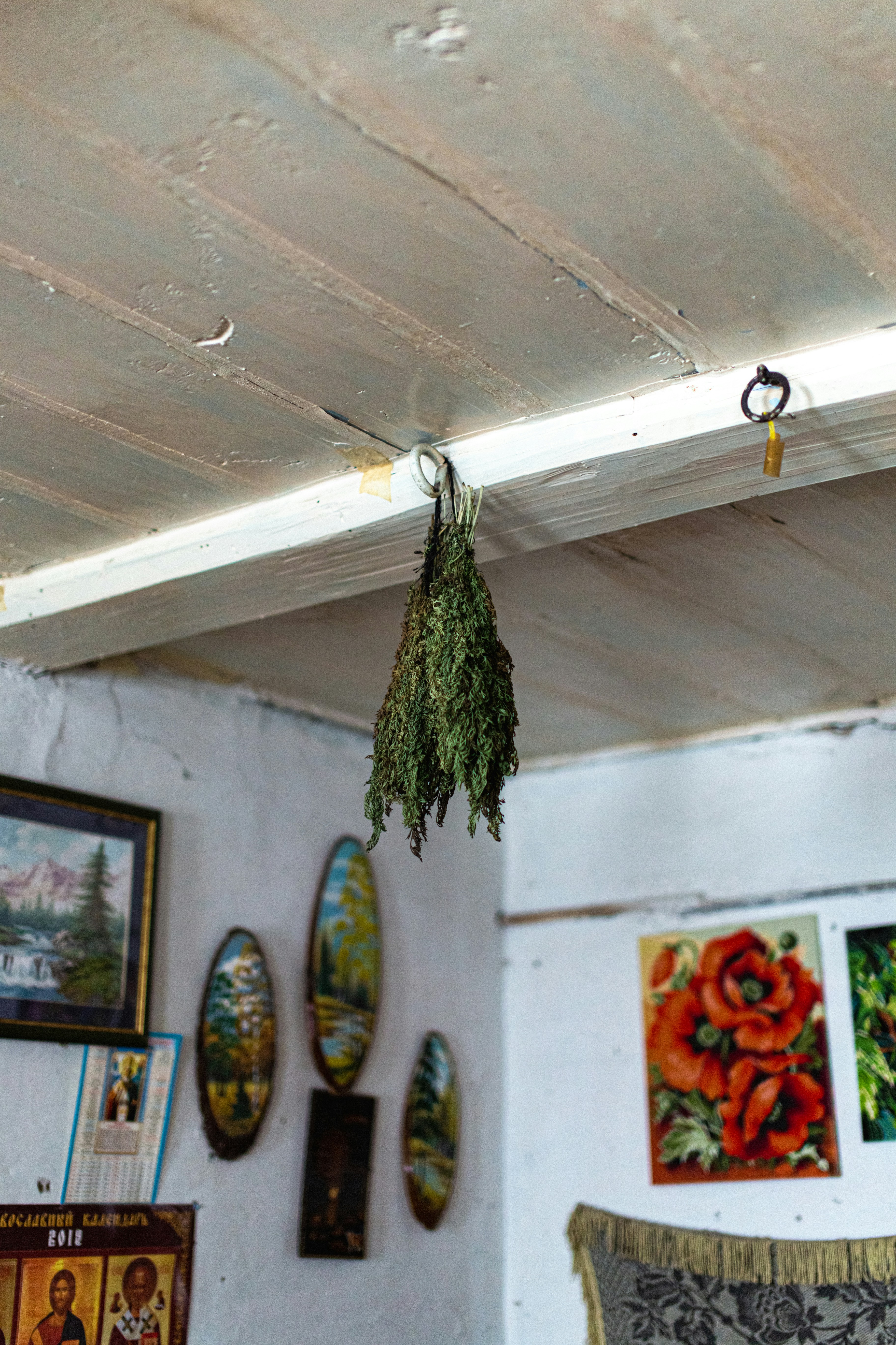 a room with a bunch of paintings on the wall