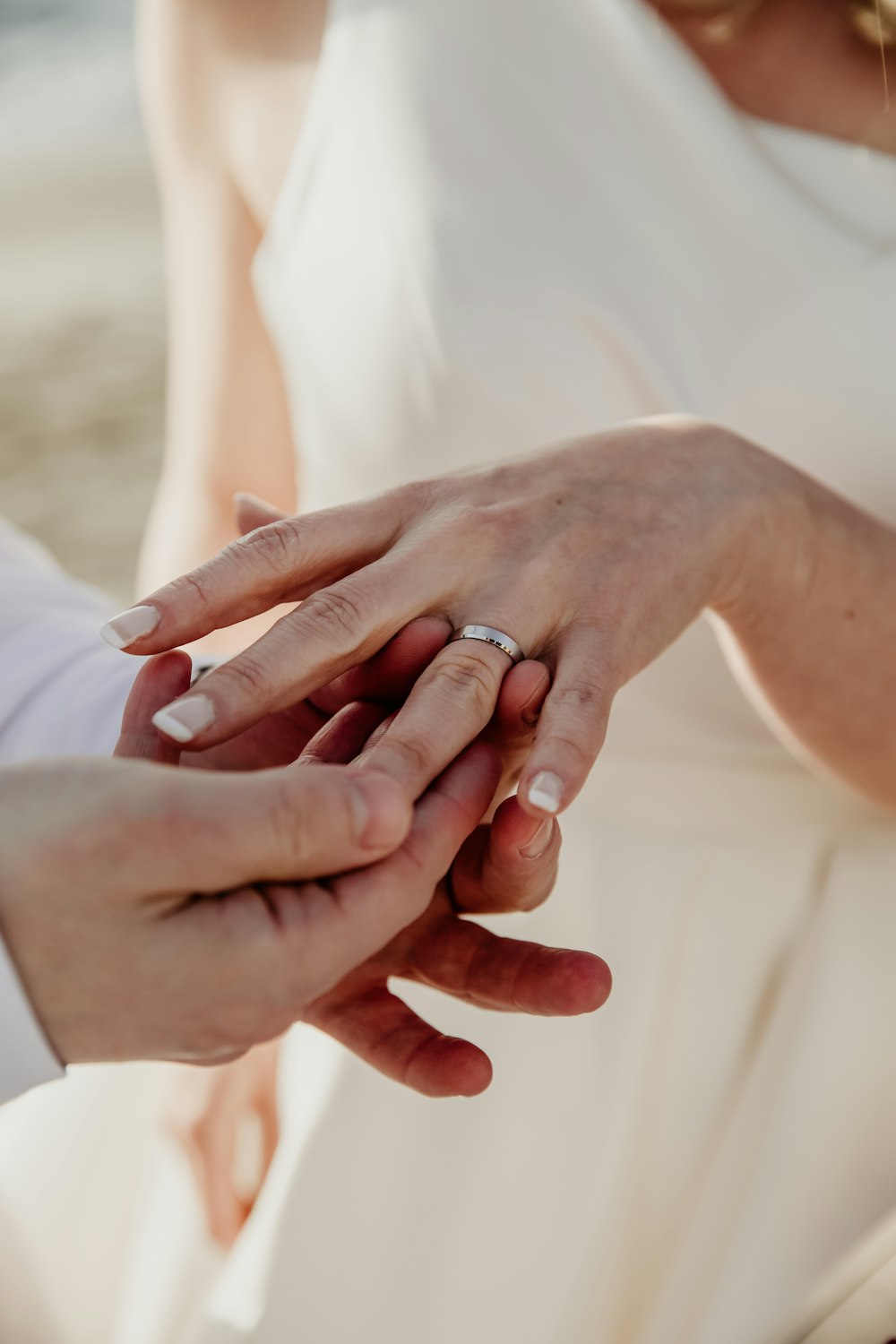 a close up of two people holding hands