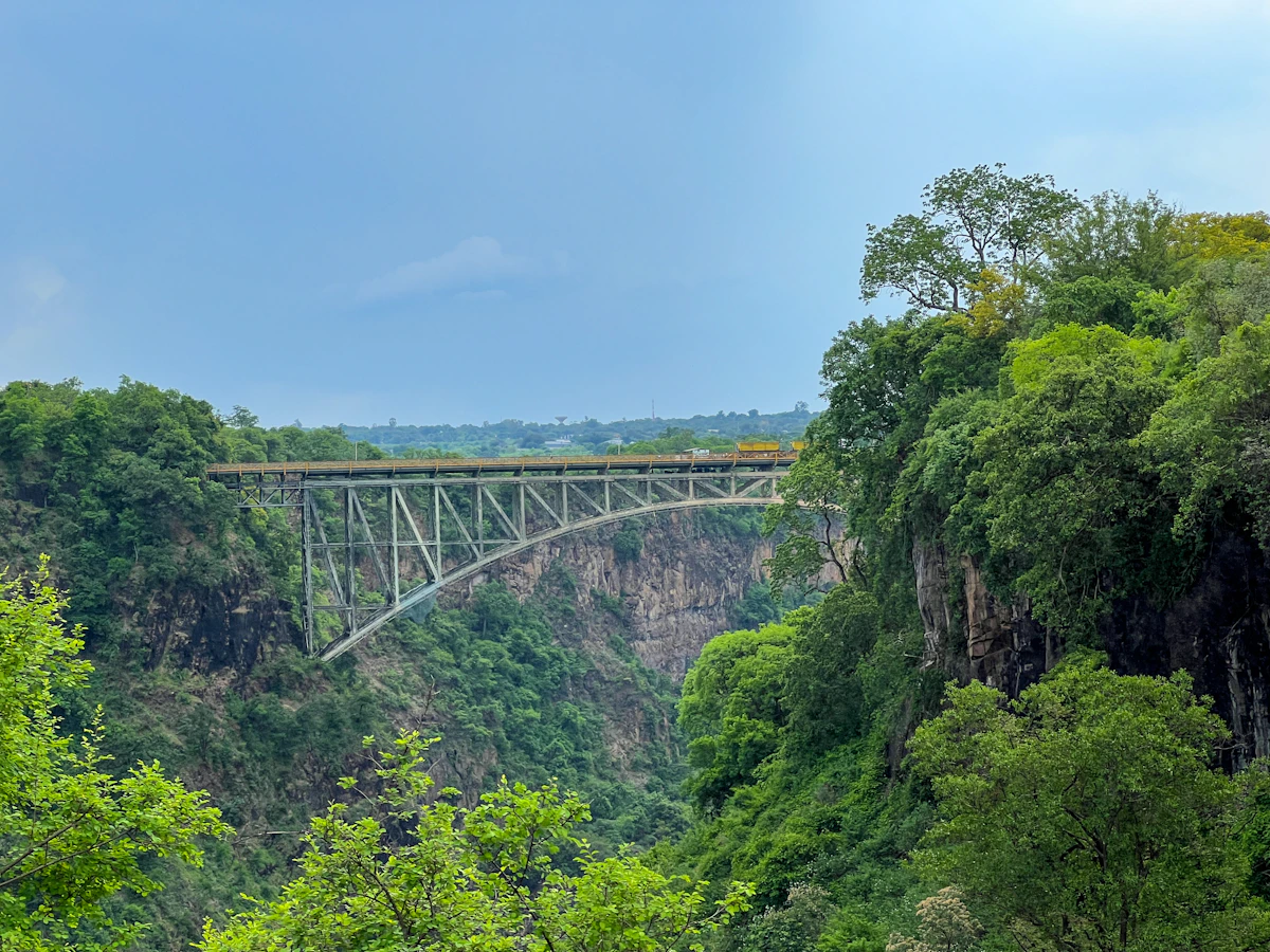 The Victoria Falls Bridge crossing the green Zambezi gorge between Zambia and Zimbabwe