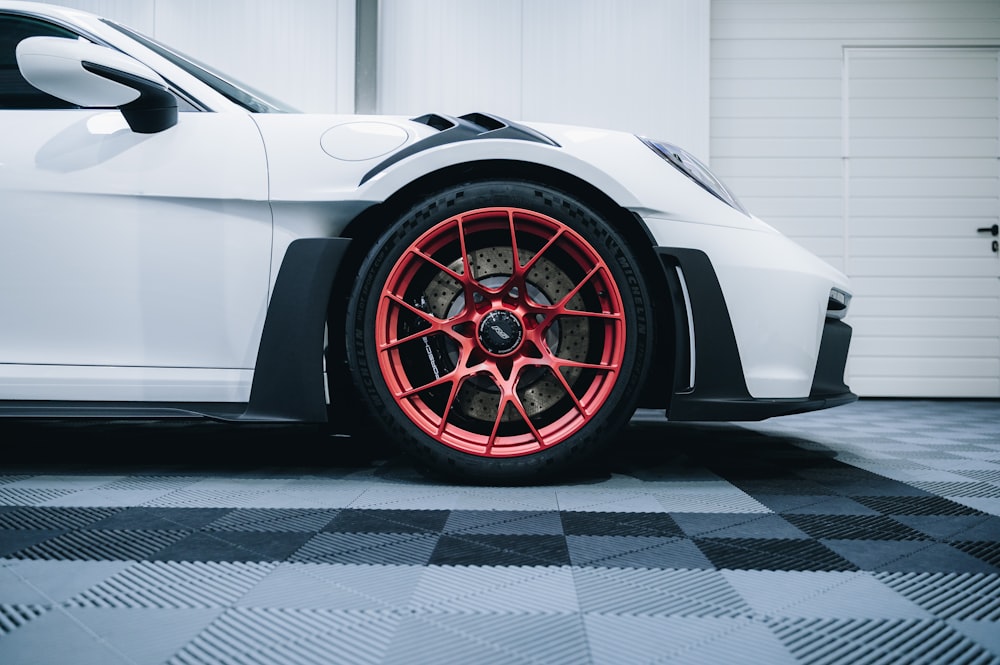 a white sports car parked in a garage