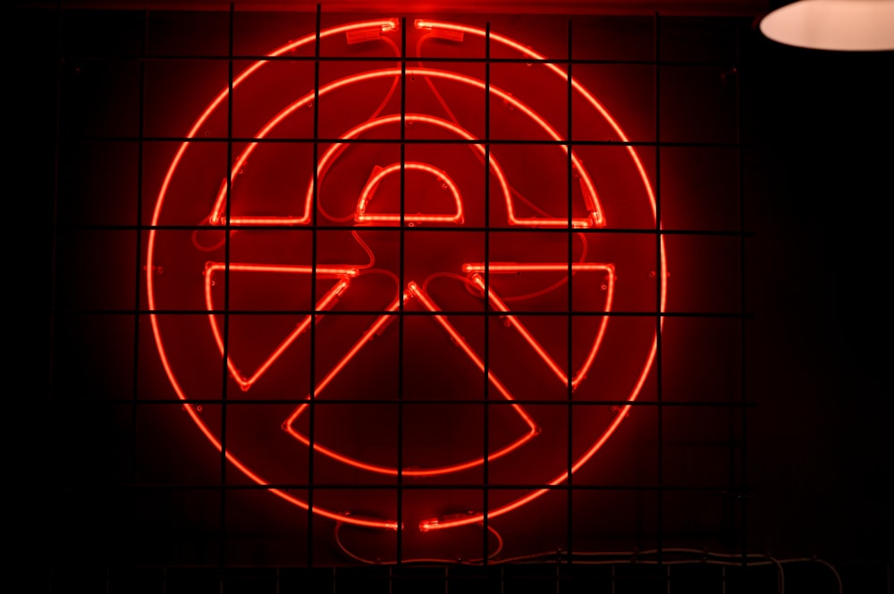 a red neon sign on a brick wall