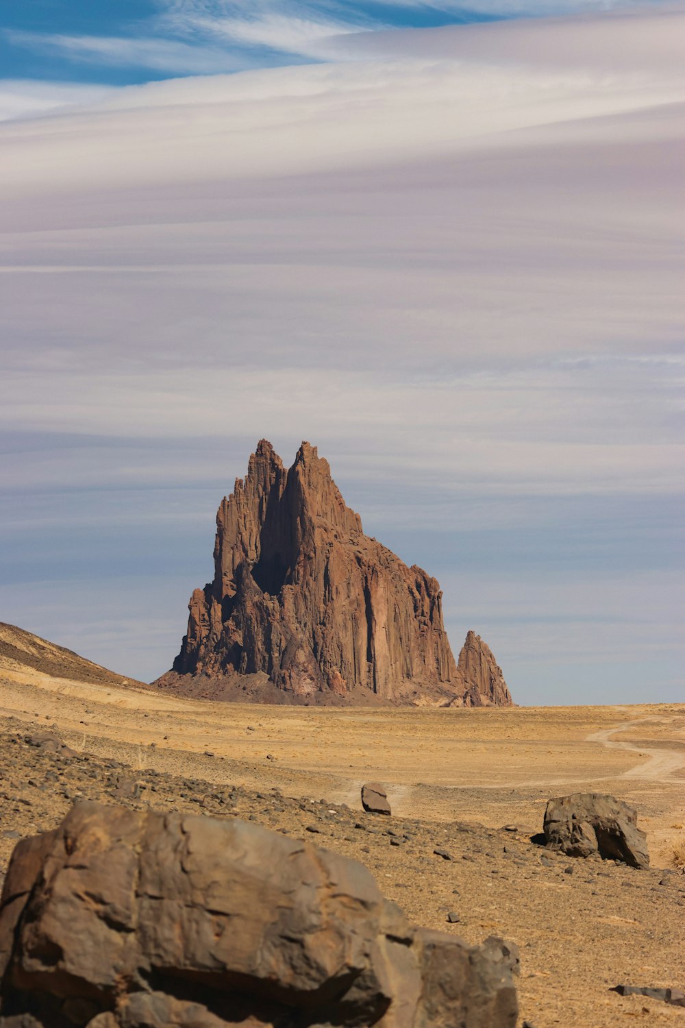 a large rock formation in the middle of a desert