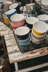 A collection of custom mugs and tumblers on a table.