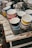 An assortment of colorful mugs with patriotic designs displayed on a wooden table.