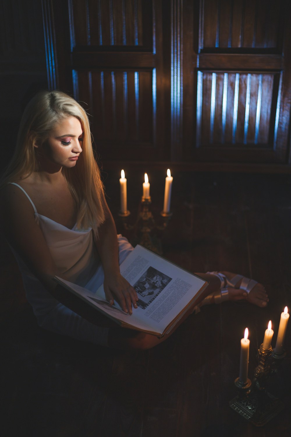 a woman sitting in a chair reading a book