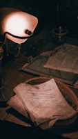 A vintage desk setting featuring a stack of aged documents with handwritten text on rough paper. The scene is dimly lit by an old-fashioned lamp that casts a warm glow across the papers and a woven basket upon which they rest. Dust and signs of age suggest an antiquated or neglected atmosphere.
