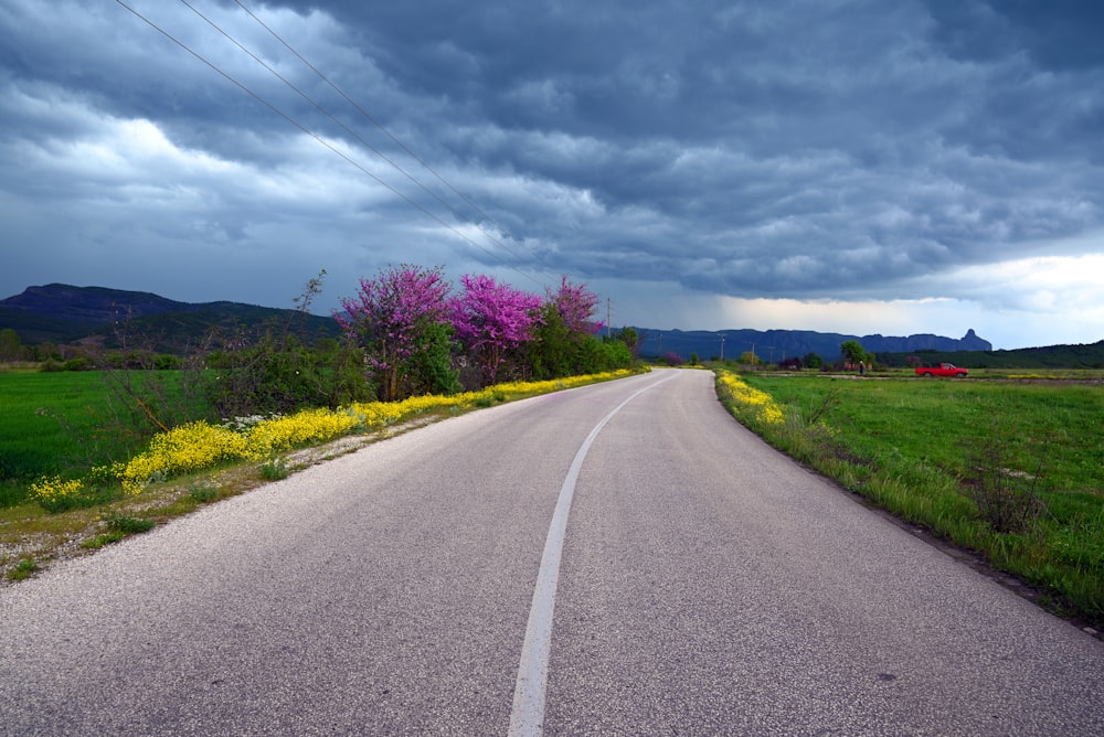 a road with a cloudy sky in the background