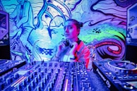 Close-up of Michelle mixing tracks on her DJ equipment in a cozy studio.