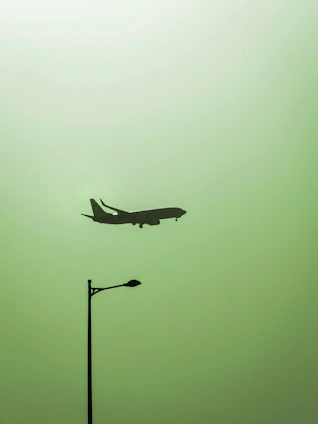 Minimalist aviation-themed poster with a vintage airplane silhouette against a calm sky