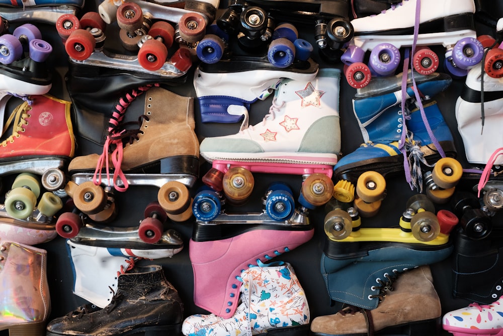 a bunch of roller skates that are stacked on top of each other