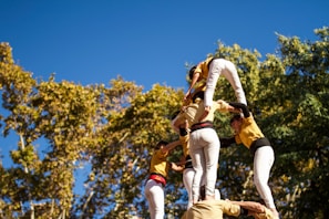 A group of Vagabondes volunteers planting trees in Deux-Sèvres, smiling under a clear blue sky