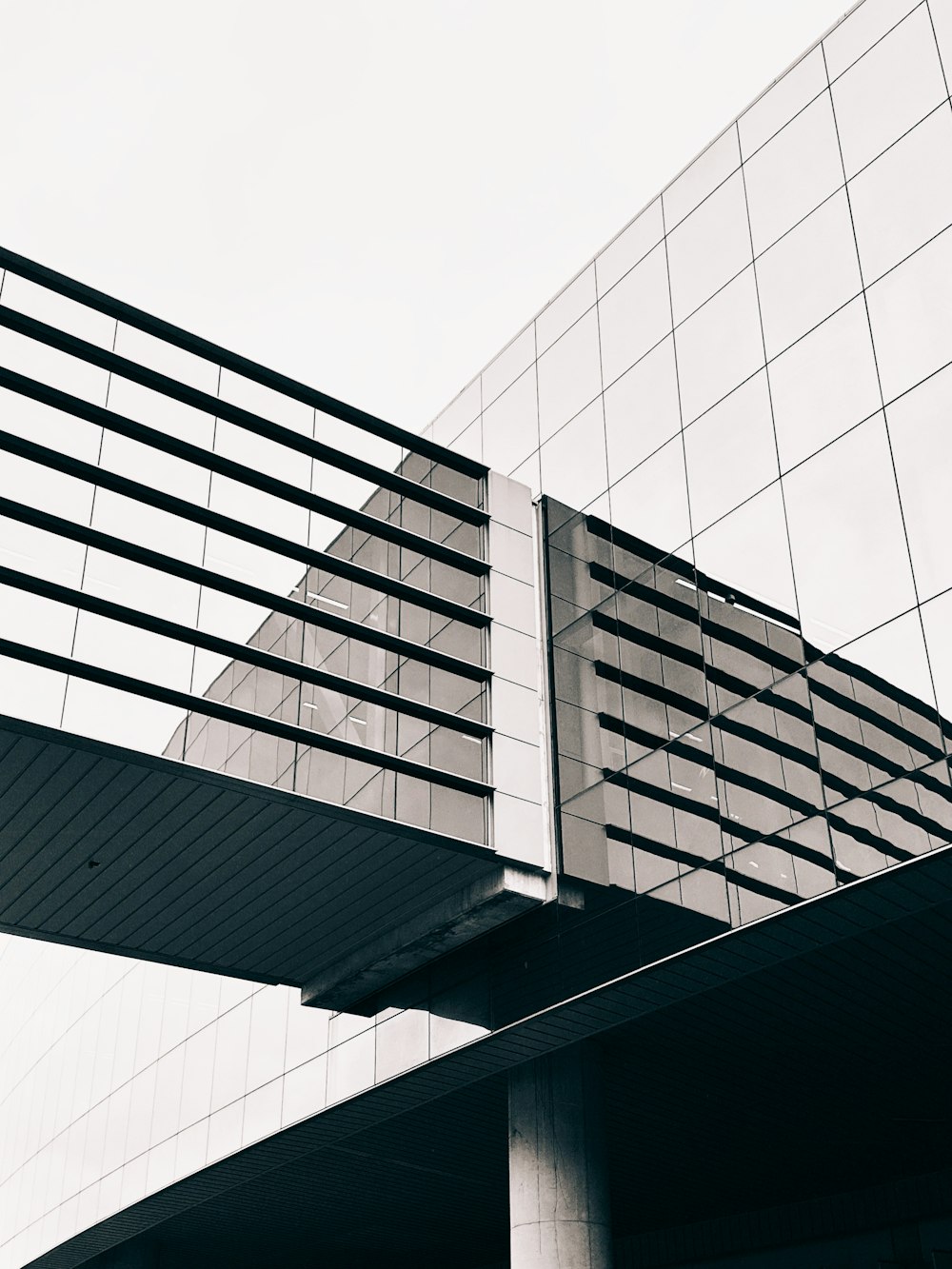 a black and white photo of a building and a bridge