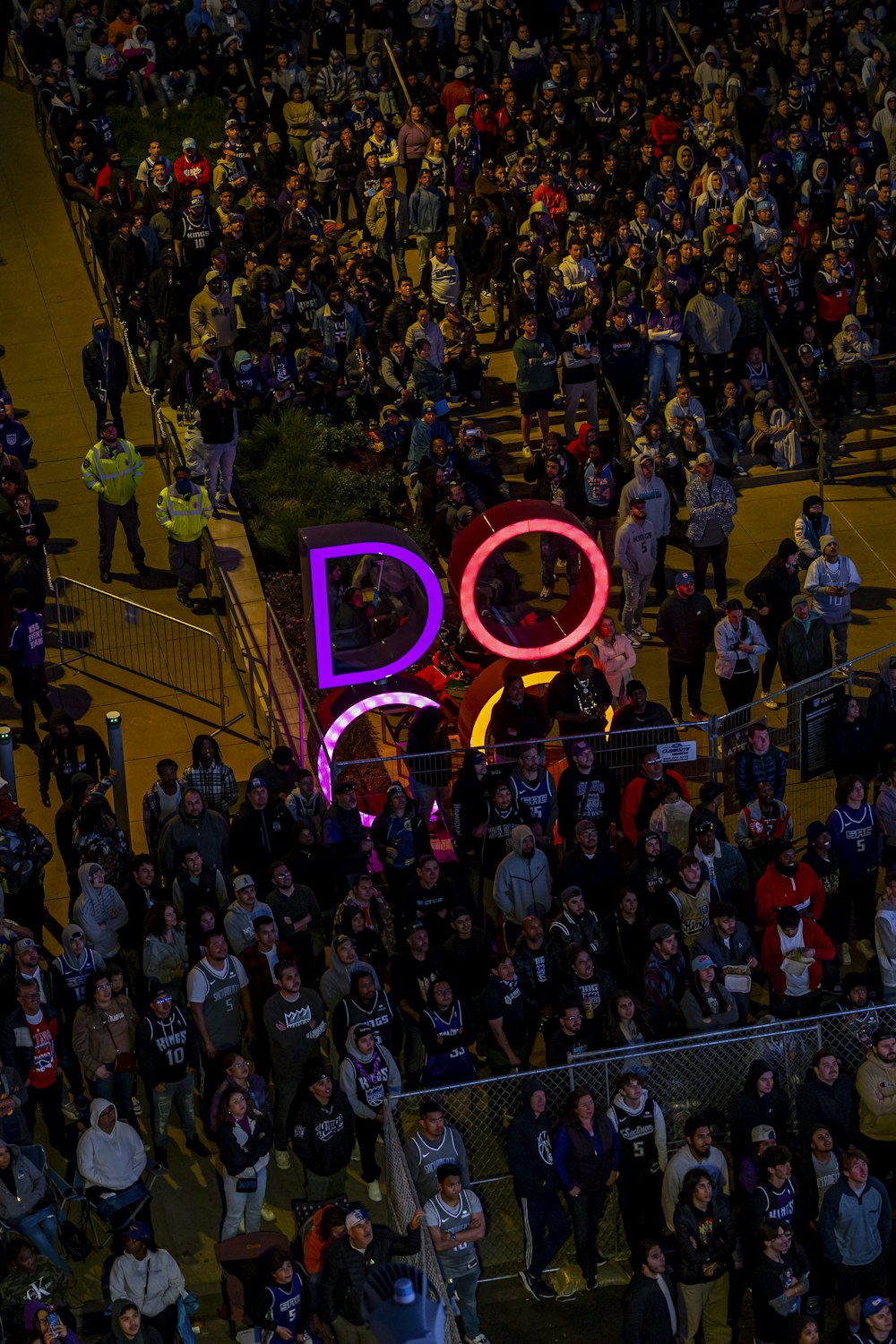 a large group of people standing around a do sign