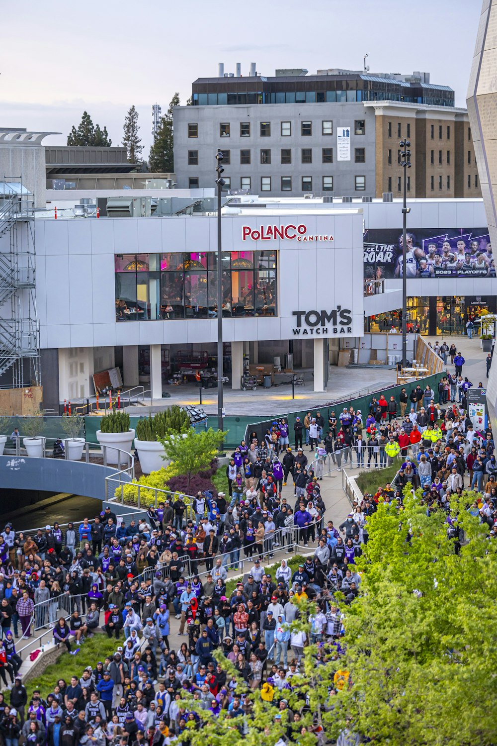 a large group of people standing outside of a building