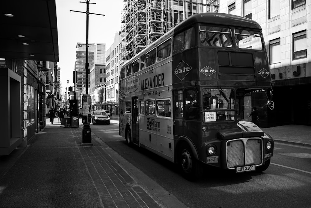 a black and white photo of a double decker bus