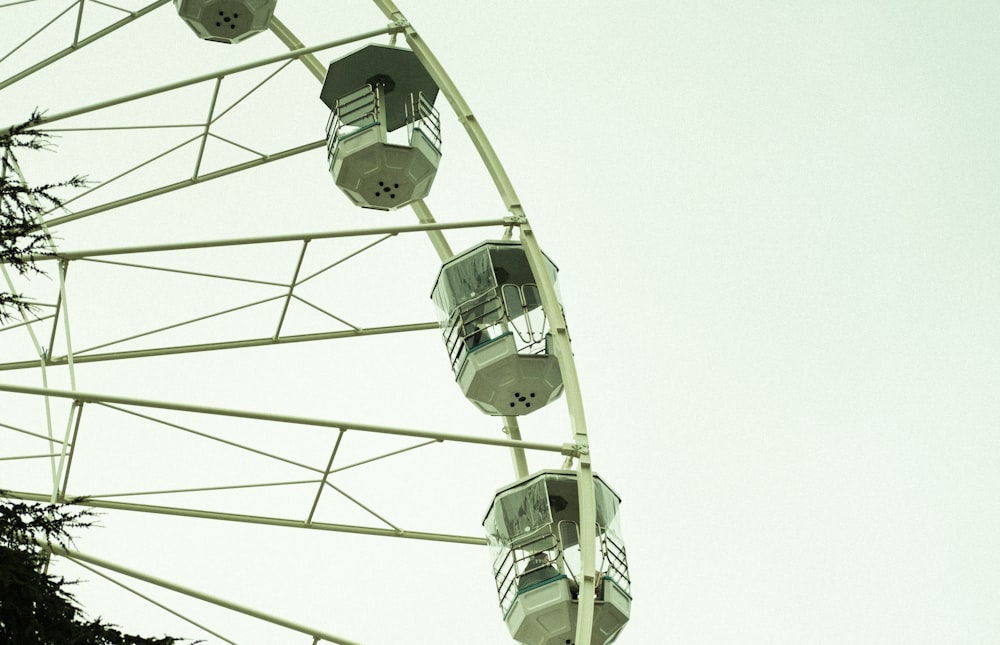 a ferris wheel is shown against a white sky