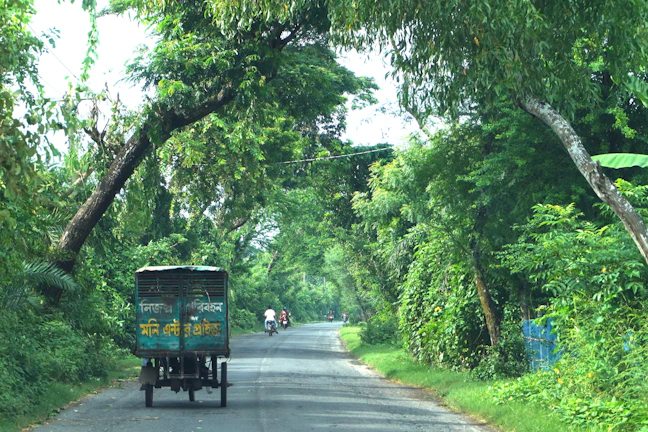 Hasby Trans Jawa vehicle driving smoothly on a highway surrounded by lush green landscapes