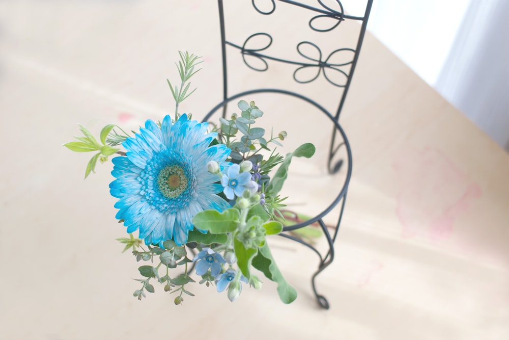 a bouquet of blue flowers sitting on top of a table