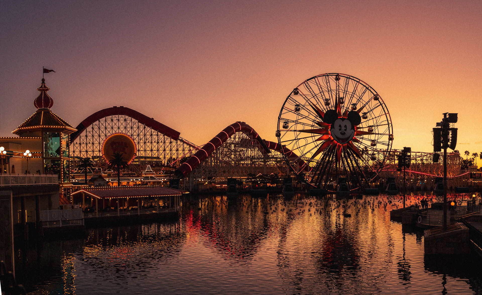 a ferris wheel sitting next to a body of water