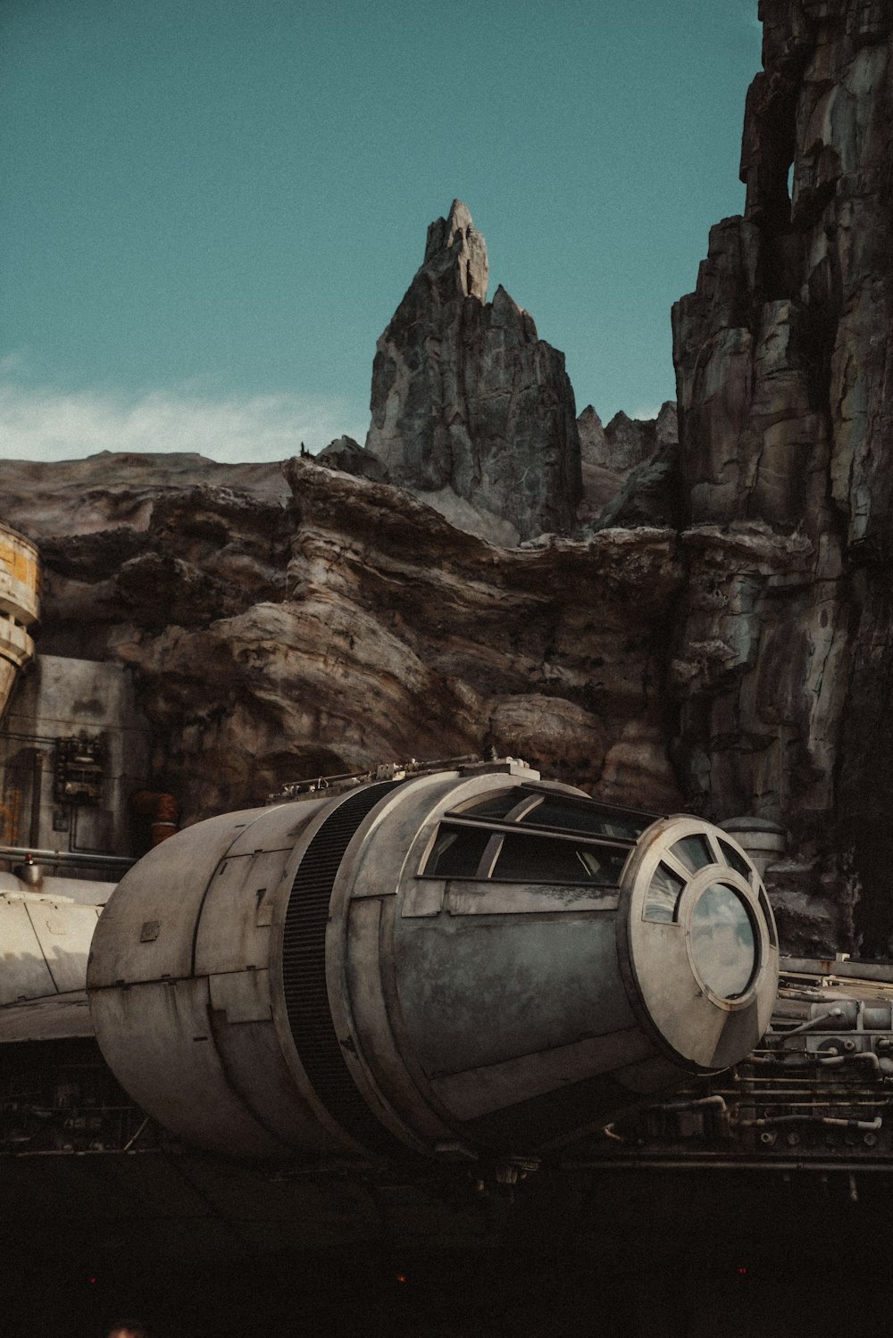a star wars vehicle parked in front of a mountain