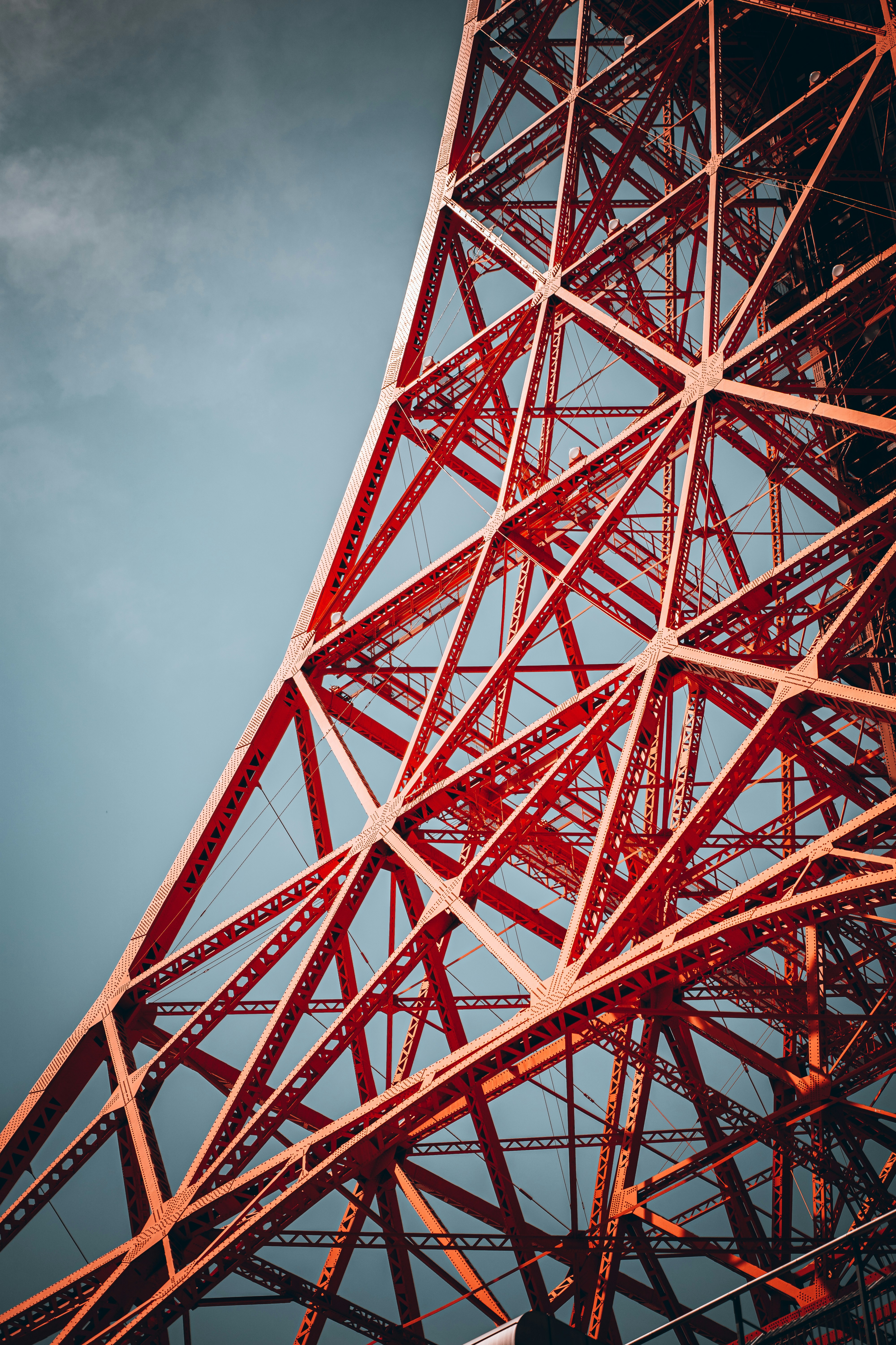 the top of a red metal structure against a blue sky
