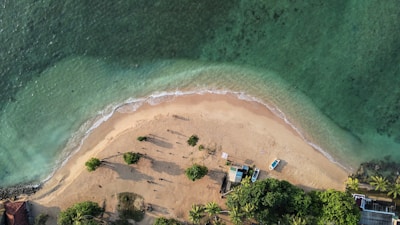 an aerial view of a sandy beach and ocean