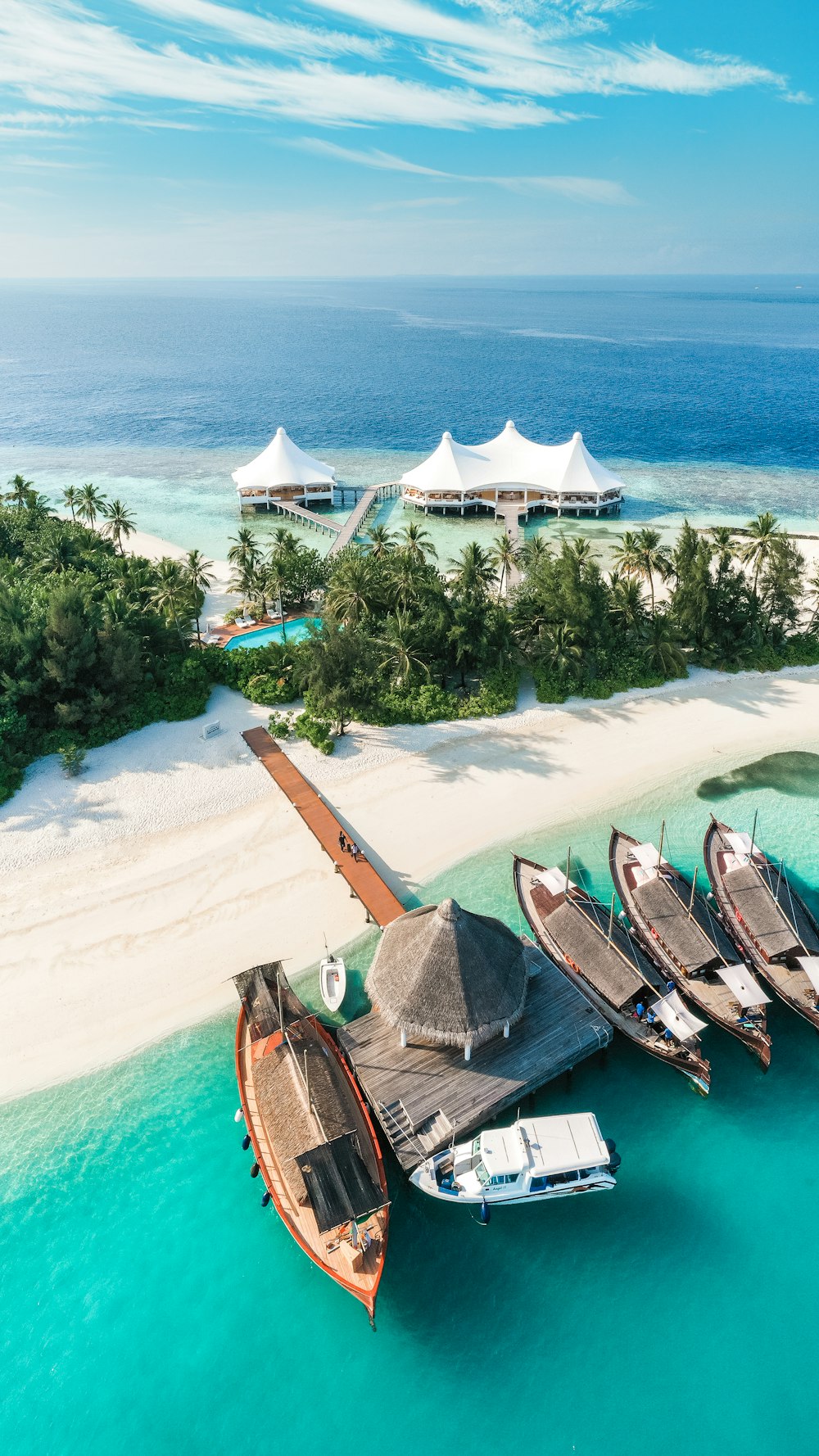 a group of boats parked on top of a sandy beach