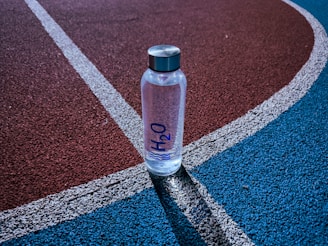 a bottle of water sitting on a tennis court