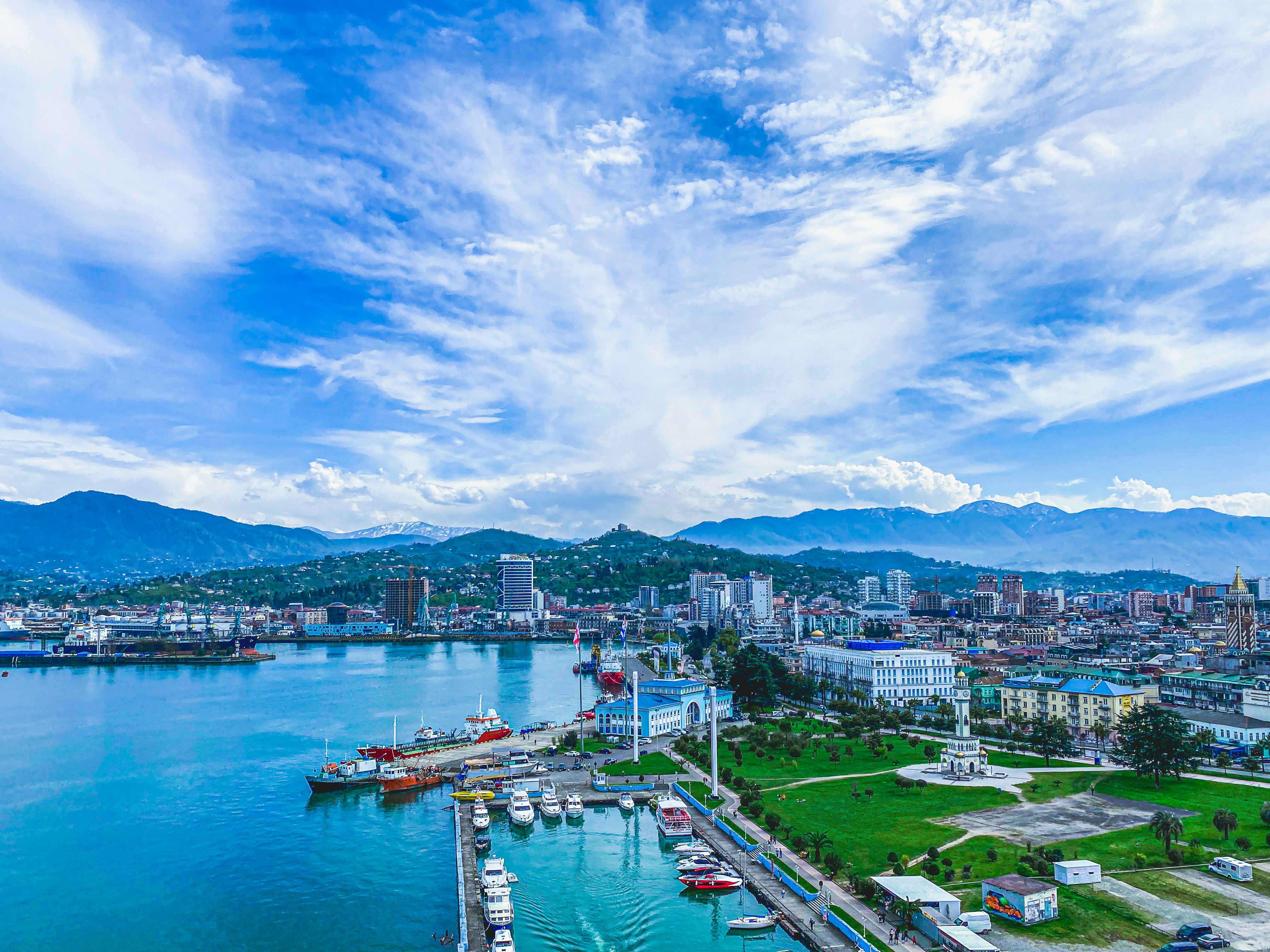 Aerial drone view of Roseau city and harbor with mountains in background
